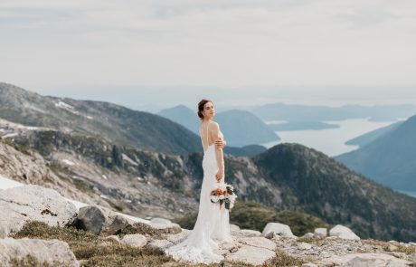 The beautiful bride in white lace gown with boho bouquet at the rocky mountain wedding