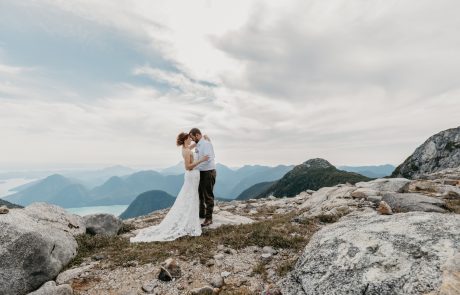 couple kiss behind Beautiful rocky mountain as background for wedding