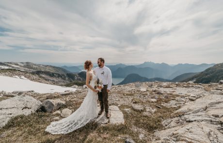 couple poses with Beautiful rocky mountain as background for wedding