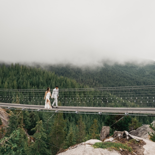 Couple walks at suspension bridge at Sea-to-sky Gondola wedding at Squamish BC