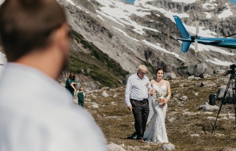 Bride walking towards the groom on a rocky mountain elopement wedding